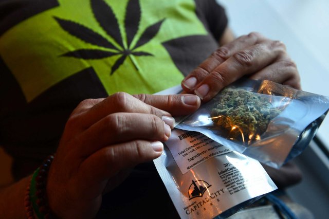A man purchases medical marijuana, the first legal sale, at Capital City Care in Washington, D.C., on July 29, 2013.