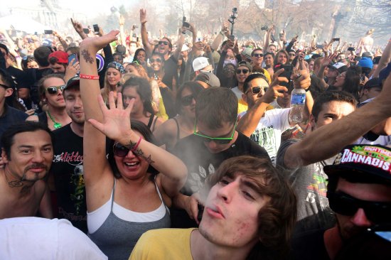 Hundreds of people light up joints, bongs, pipes and marijuana cigarettes at exactly 4:20 pm during the Colorado 420 Rally at Civic Center Park in Denver on April 20, 2014.
